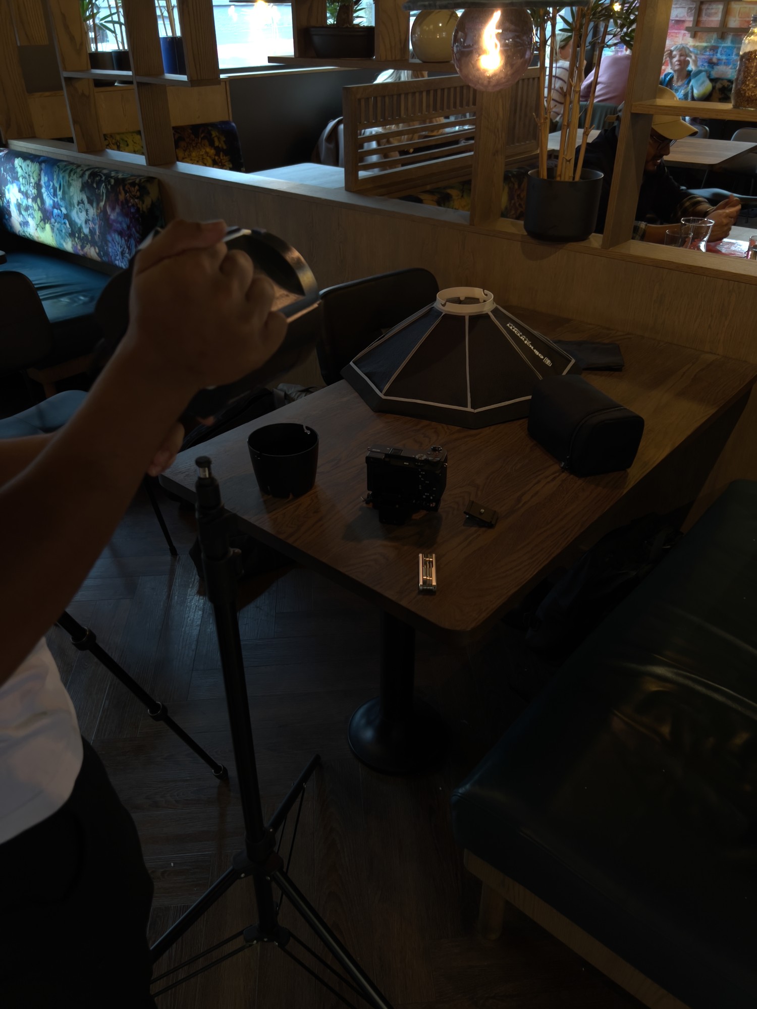 Crew member holding a reflector beside camera and lighting equipment at YIPS Stavanger